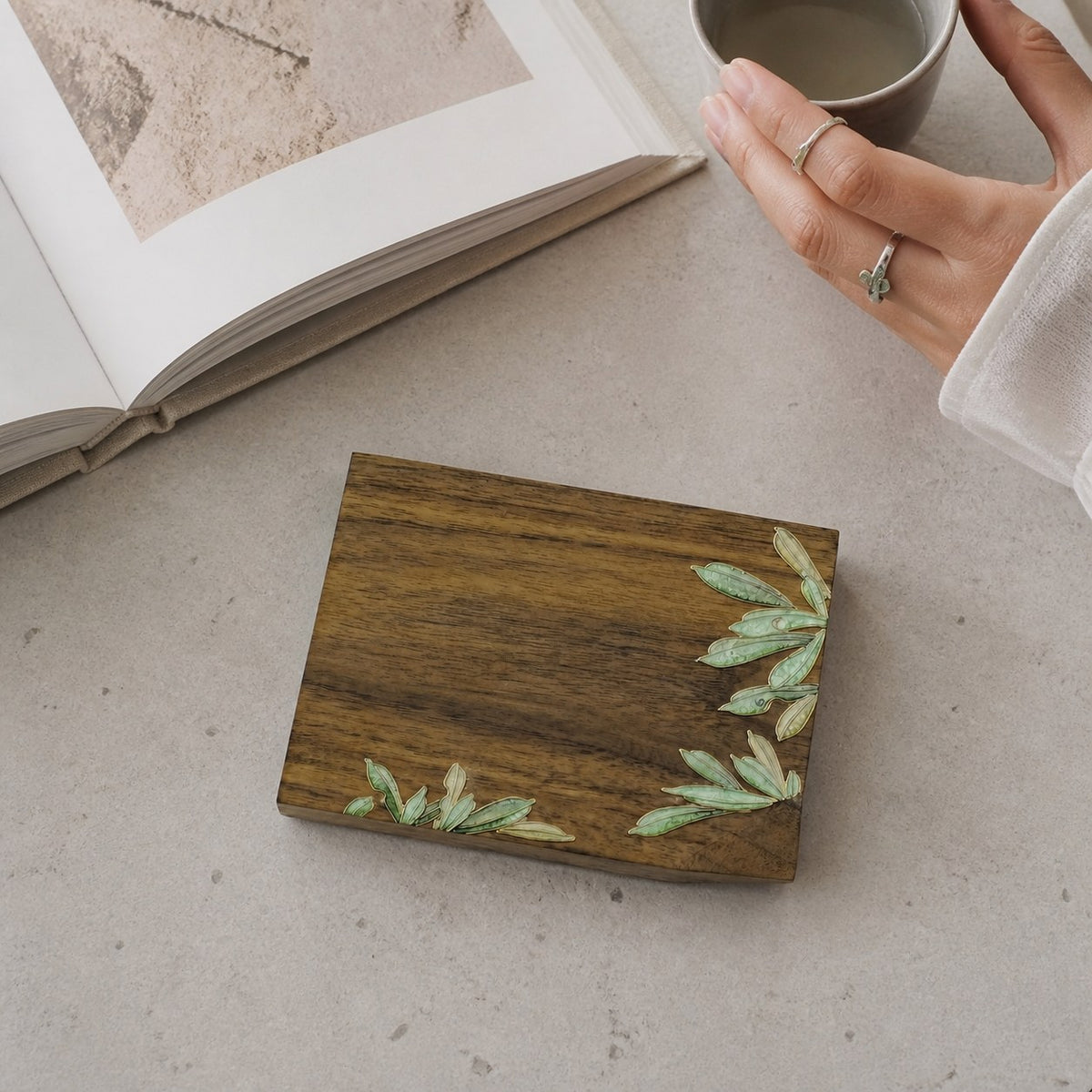Square walnut cloisonne coaster: Green leaf design beside an open book