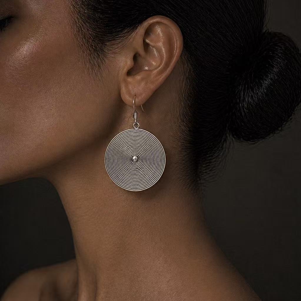 Handcrafted Miao Silver Spiral Disc Earrings – Minimalist Ethnic Statement Jewelry | Orithing