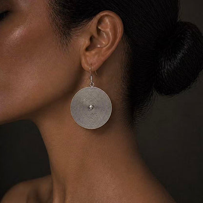 Handcrafted Miao Silver Spiral Disc Earrings – Minimalist Ethnic Statement Jewelry | Orithing