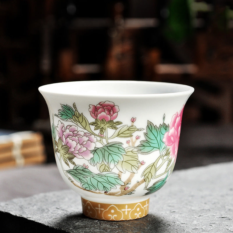 Dehua porcelain tea cup with layered pink and purple flowers and broad green leaves