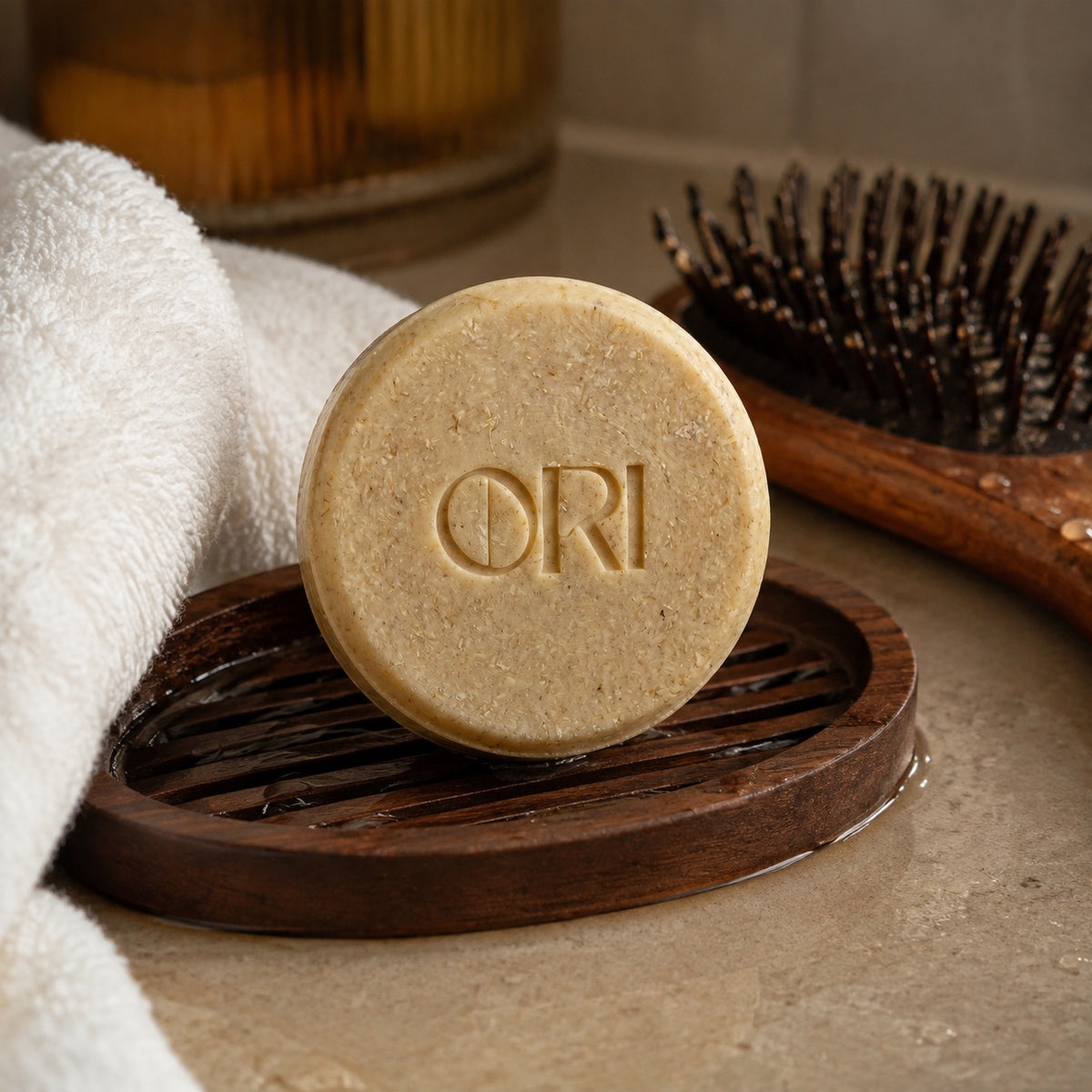 Ginger and astragalus shampoo bar: On a wooden dish beside a hairbrush