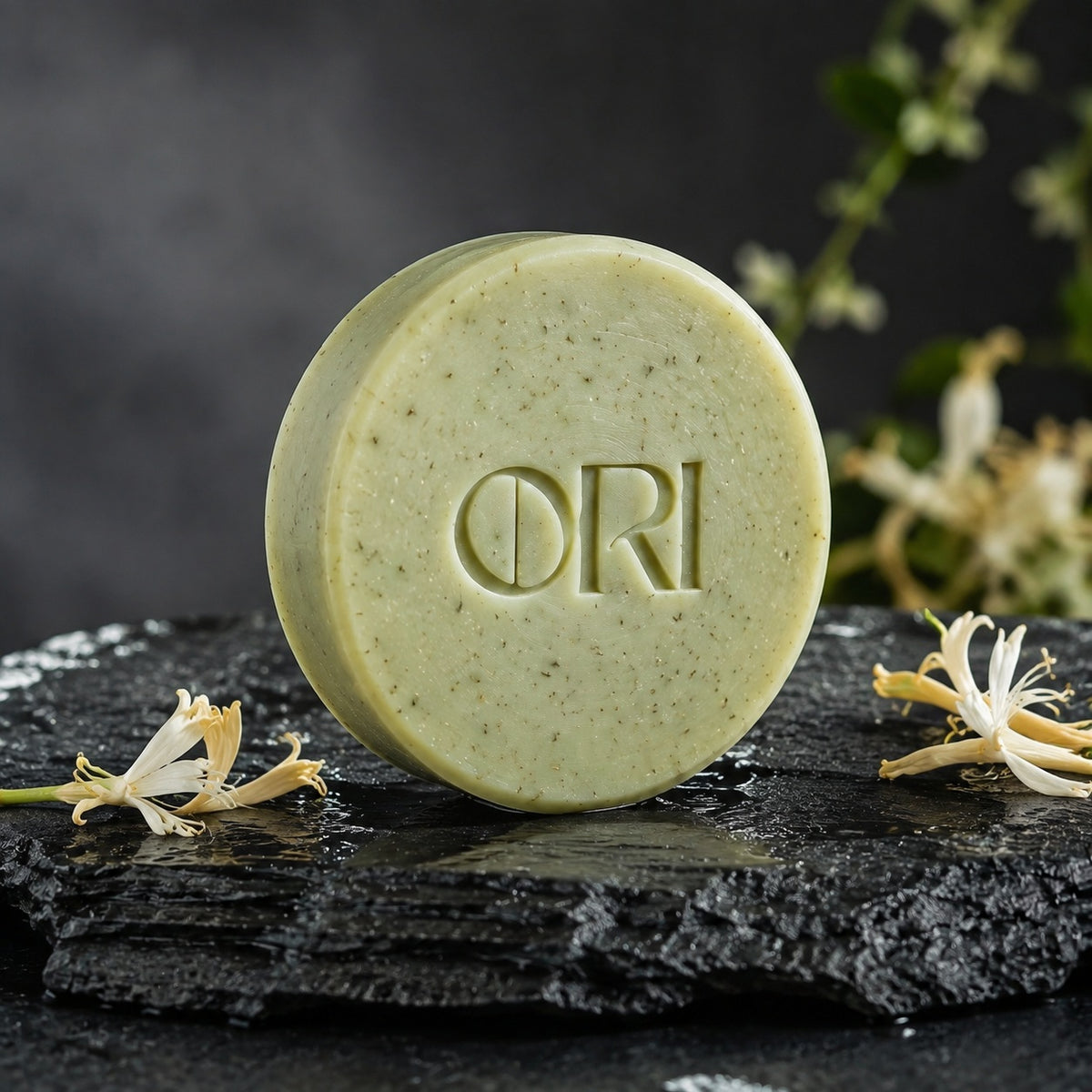 Honeysuckle soap bar: Standing on slate beside flowers