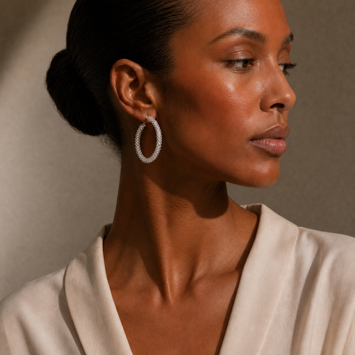 Miao silver hoop earrings: Hoop earrings worn with a pale blouse