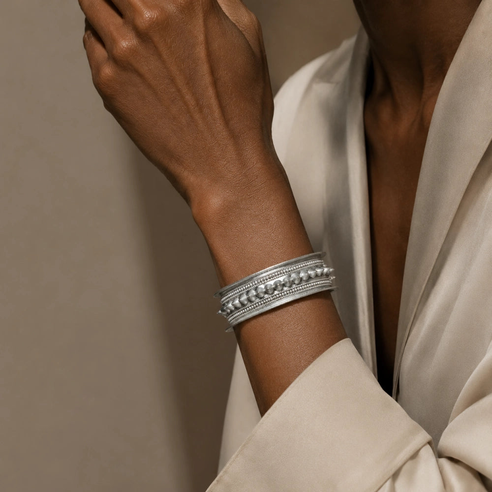 Miao silver patterned bracelet: Close-up of patterned bracelet on a raised wrist