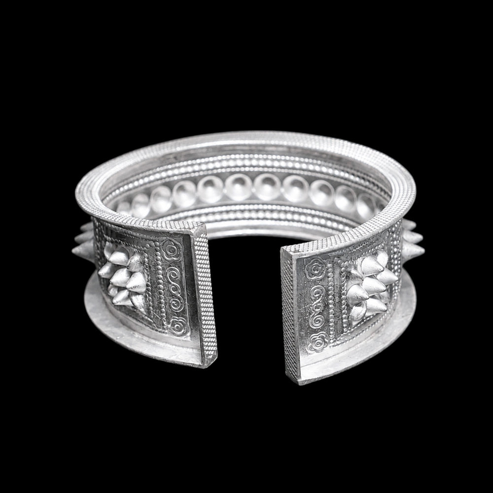 Miao silver patterned bracelet: Open back against a black background