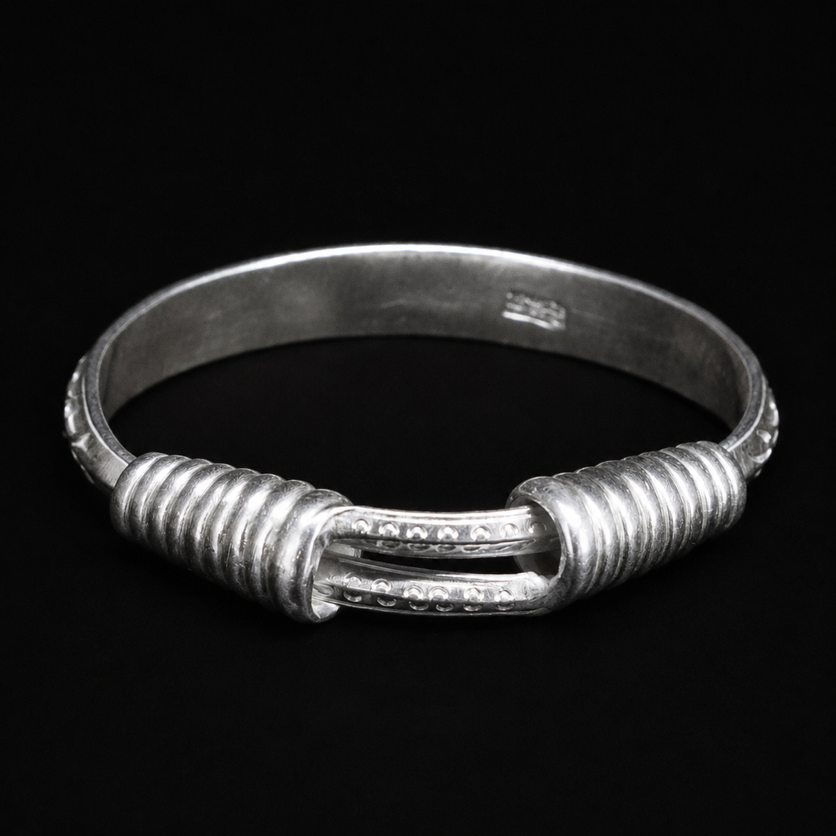 Miao silver spiral bracelet: Front view of coiled ends and wider band