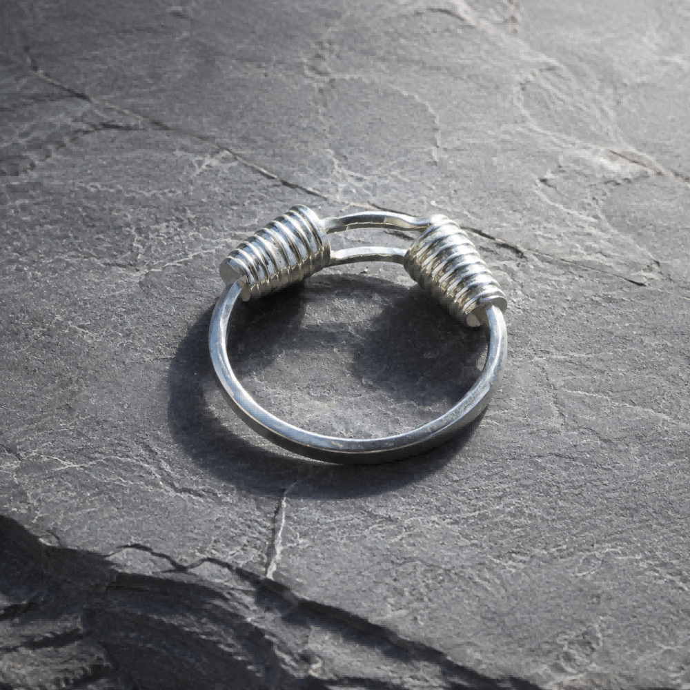 Miao silver spiral bracelet: Open bracelet on gray stone