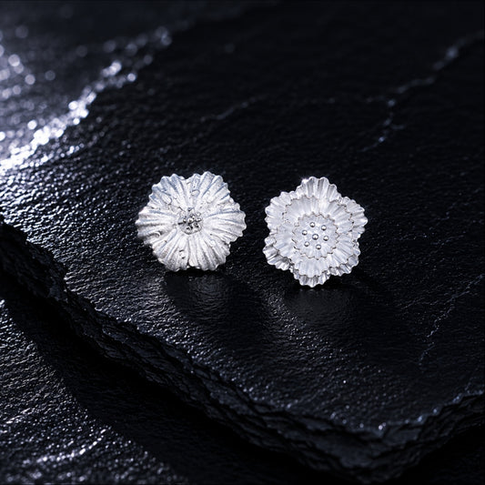 Miao silver textured flower studs: Pair of textured flower studs on dark slate