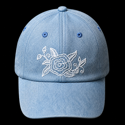 Qiang embroidered denim baseball cap: Front view showing white floral embroidery and curved brim