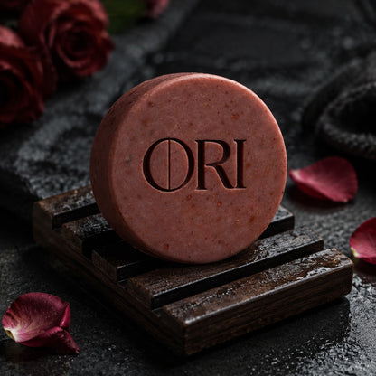 Rose milled soap bar: On a dark wooden dish with rose petals