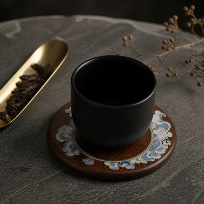 Round red sandalwood cloisonne coaster: Pale blue floral design beneath a black cup
