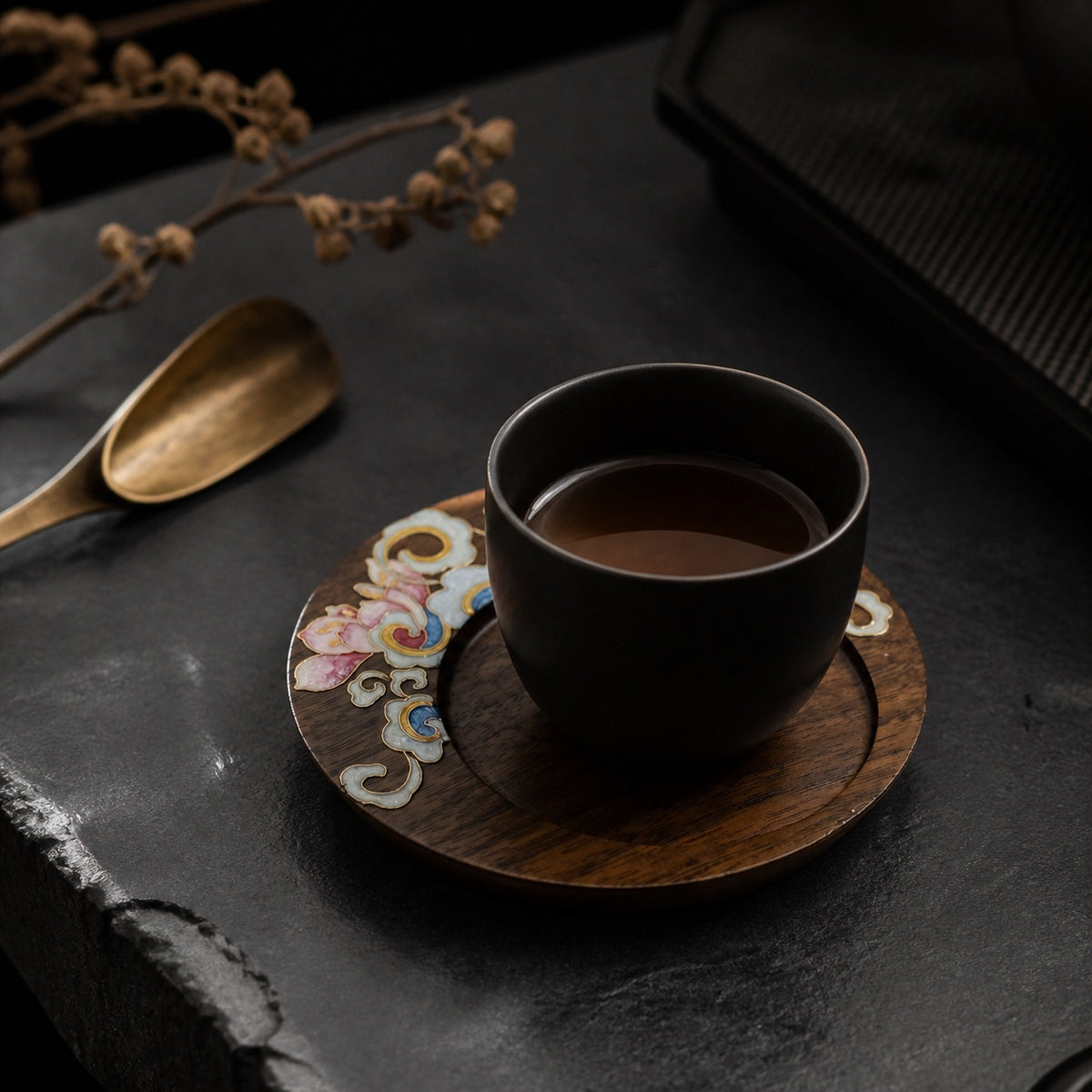 Round walnut cloisonne coaster: Pink floral design beneath a black cup