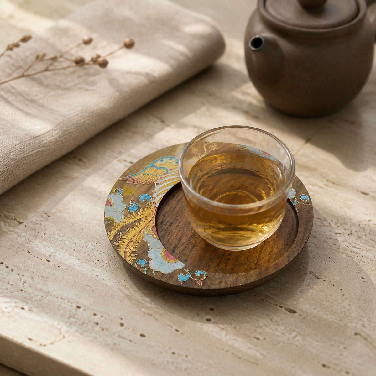 Round walnut cloisonne coaster: Yellow floral design beneath a glass teacup