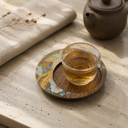 Round walnut cloisonne coaster: Yellow floral design beneath a glass teacup