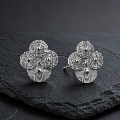 Silver spiral-disc cluster studs: Cluster studs standing on gray slate