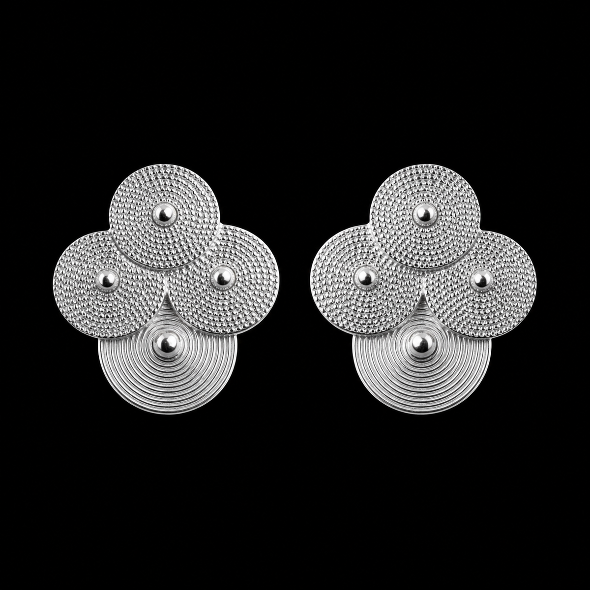Silver spiral-disc cluster studs: Front view of the cluster stud pair on black