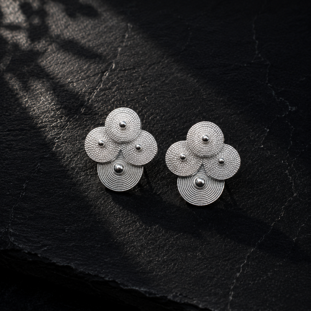 Silver spiral-disc cluster studs: Pair of cluster studs on slate with leaf shadows