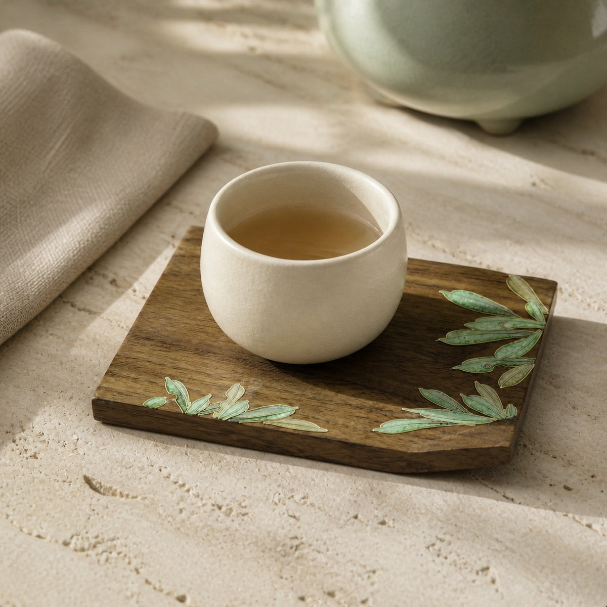 Square walnut cloisonne coaster: Green leaf design beneath a white cup