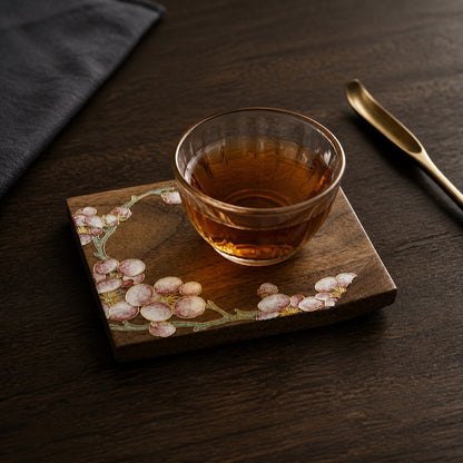 Square walnut cloisonne coaster: Pale blossom design beneath a glass teacup