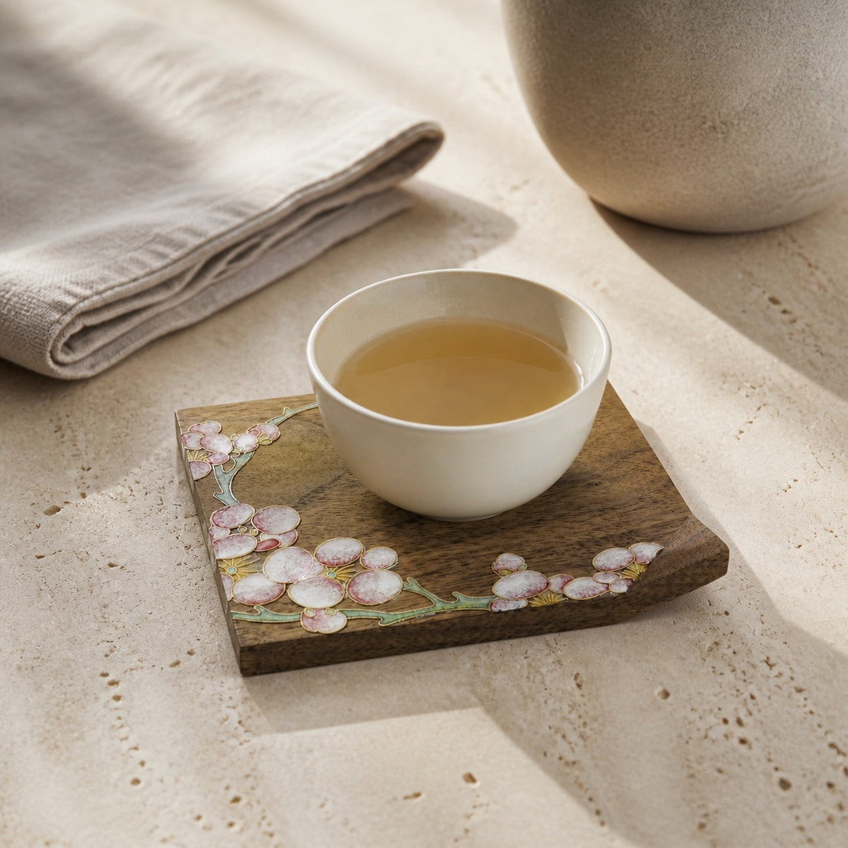Square walnut cloisonne coaster: Pale blossom design beneath a white cup
