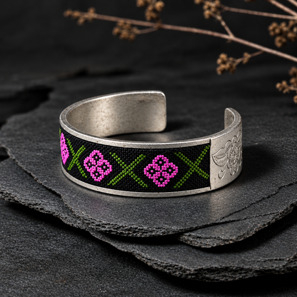 Xixiu embroidered alloy cuff: Geometric embroidery shown on a dark slate stand