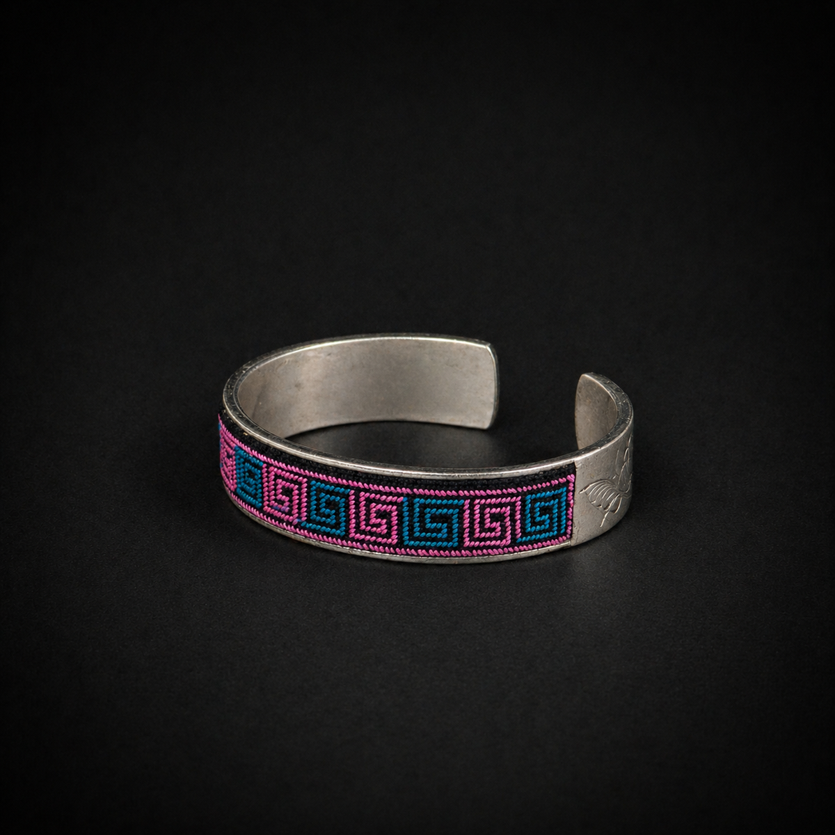 Xixiu embroidered silver cuff: Pink and blue cuff on a dark background