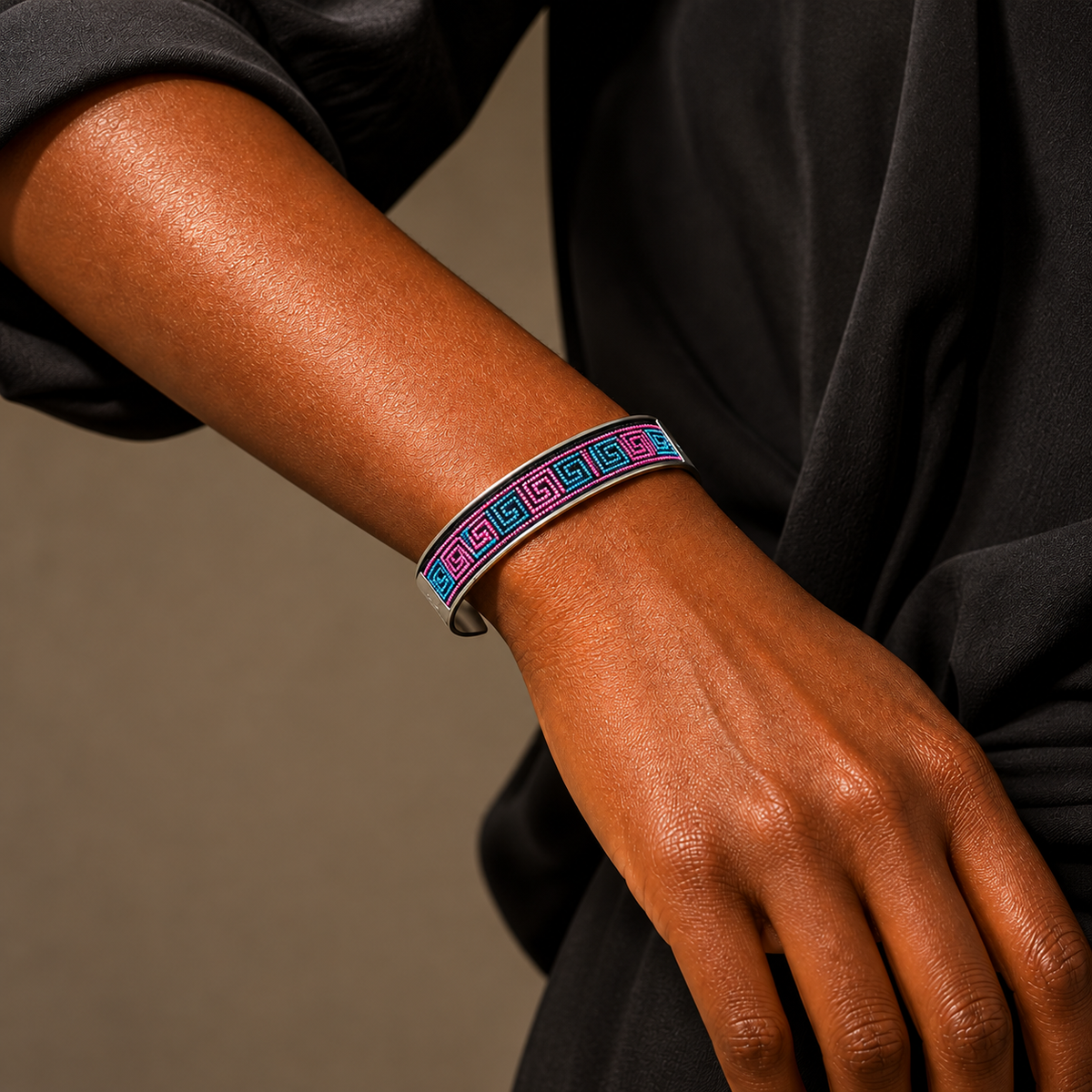 Xixiu embroidered silver cuff: Pink and blue embroidered cuff worn on a wrist